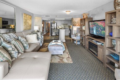 Living room with visible vents, dark colored carpe