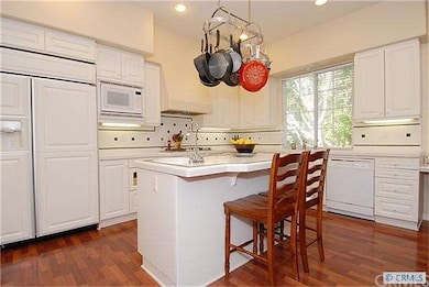 kitchen with island and  built-in refrigerator