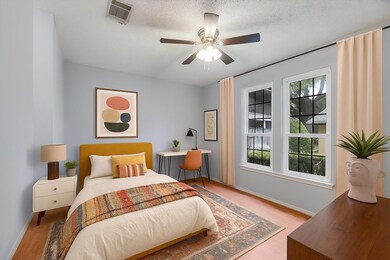 Bedroom with wood finished floors and a ceiling f