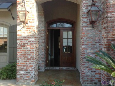 FRONT ENTRANCE WITH FRENCH DOORS AND GAS LAMPS
