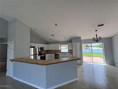 Kitchen with white cabinets, stainless steel appli