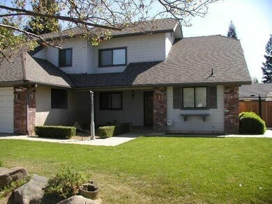 Nice entry way with patio and an elevated landscap