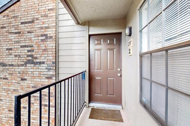 Property entrance featuring brick siding