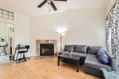 Living room with a fireplace, wood finished floor
