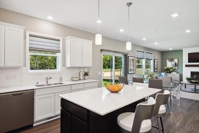 Enjoy plenty of seating at the kitchen island and dining area adjacent to the kitchen. Perfect for entertaining or having a family meal together. (Model photo)