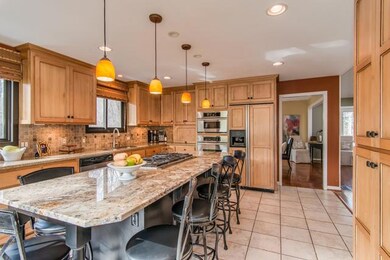 Note the back wall with custom pantry. Additionally, the refrigerator has cabinetry doors, double SS ovens, pendant lighting over island, marble backsplash. Did I mention the view? I did mention privacy? Right?