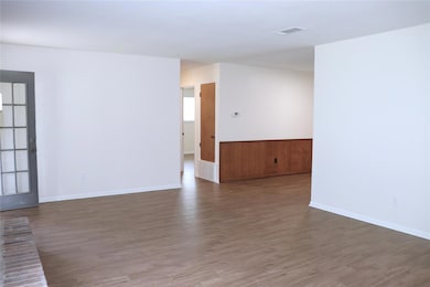 Unfurnished room featuring baseboards, visible ve