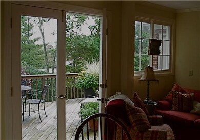 French doors in kitchen open to spacious deck and lush backyard.  