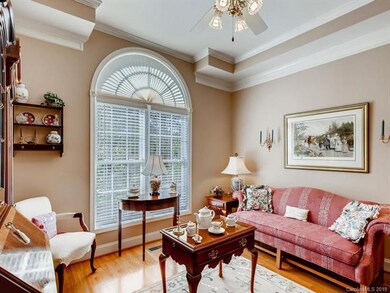 Formal living room with tray ceiling and custom mo