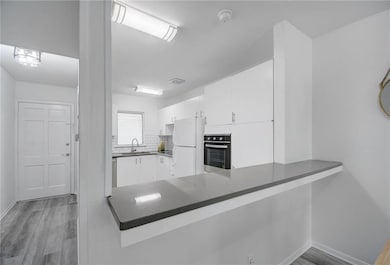 Kitchen featuring freestanding refrigerator, a pe