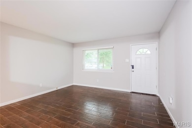 Foyer featuring baseboards and wood finish floors