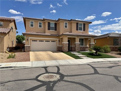 View of front facade featuring stucco siding, a ti