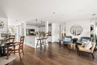 Living room with dark wood-style flooring and recessed lighting