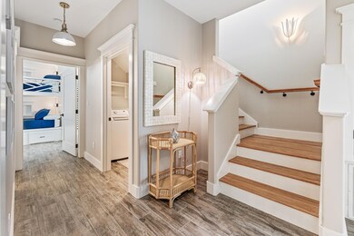 Stairs featuring washer / clothes dryer, wood fin