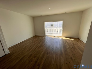 Unfurnished room with dark wood-style flooring