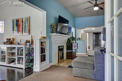 Living room featuring a fireplace, carpet floors, 