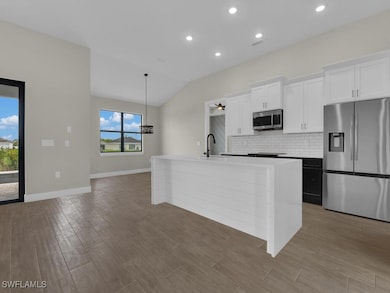 Kitchen with stainless steel appliances, an island
