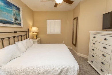 Carpeted bedroom with baseboards and ceiling fan