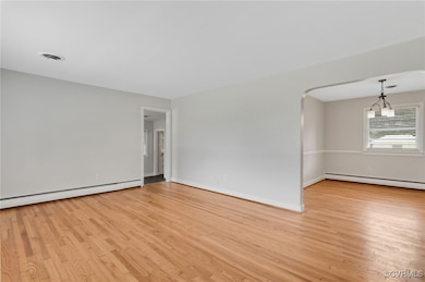 Family room with refinished hardwood floors, visib