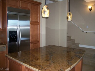 Kitchen with built in refrigerator, brown cabinets