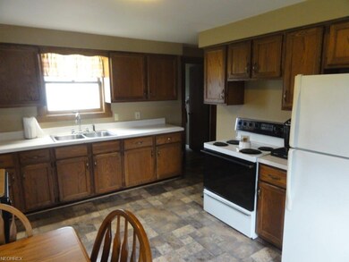 Another view of the kitchen showing more cabinets.
