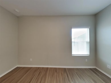 Unfurnished room with dark wood-style floors