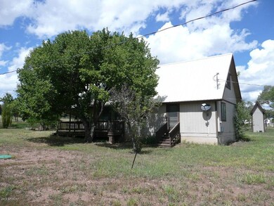 Chalet S side & well pump hs