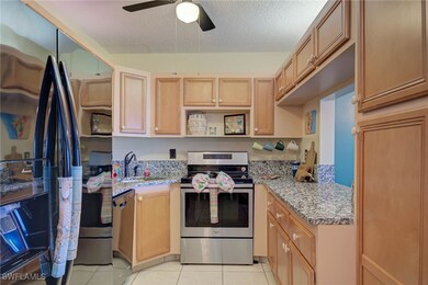 Kitchen with stainless steel range with electric c