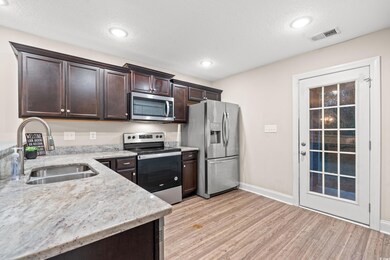 Kitchen with stainless steel appliances, sink, dar