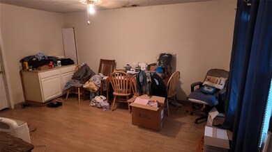 Miscellaneous room featuring a textured ceiling, l