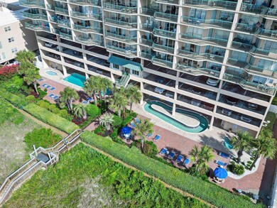 Aerial view of apartment complex / building and a pool