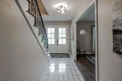 Entryway featuring french doors, wood-type floorin
