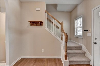 Stairway with wood finished floors and arched walkways