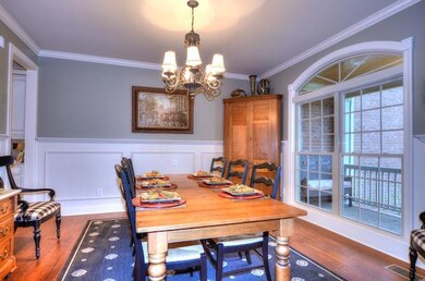 SPACIOUS DINING ROOM WITH CUSTOM WAINSCOTTING, PLANTATION SHUTTERS AND LOTS OF ROOM FOR ENTERTAINING