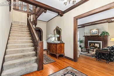 Stairway with ornamental molding, a brick fireplac