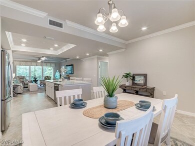 Dining room with crown molding and ceiling fan wit