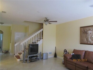 View of living area and stairway to 2nd floor