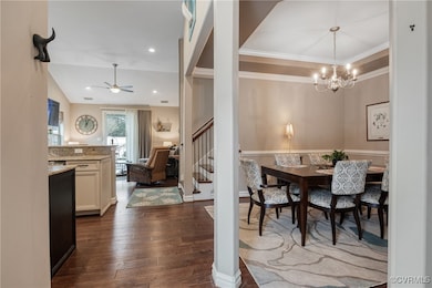 Dining room featuring crown molding, dark wood-typ