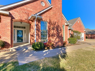 View of exterior entry with a yard and a garage