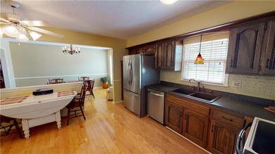 Kitchen has beautiful wood floors and stainless ap
