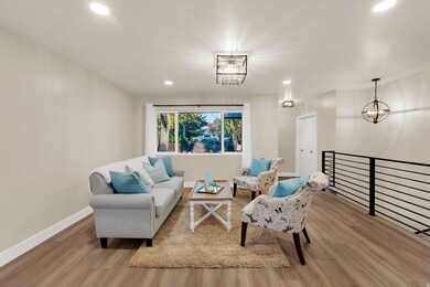 Living area with recessed lighting, light wood-style flooring, and a chandelier