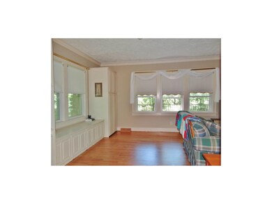 The great room also offers a box window, large cabinetry & gleaming wood floors!