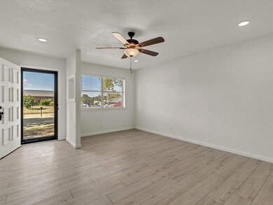 Spare room with ceiling fan and light wood-type fl