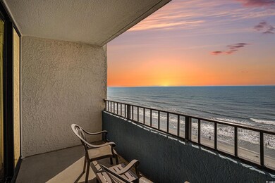 Balcony with view of water and beach