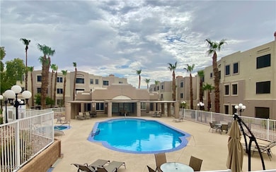 Community pool with fence and a patio area