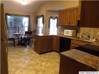 Large roomy kitchen includes a dining area.
