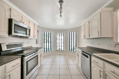 Kitchen with charming breakfast nook lined by bay
