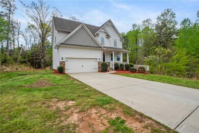 Craftsman inspired home featuring a porch, drivewa