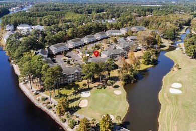View of property location featuring a large body of water and a golf club