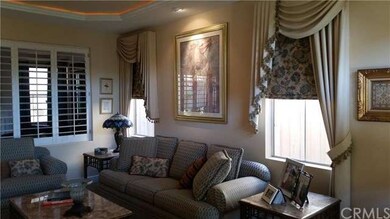Living Room with Plantation Shutters Separating Fa